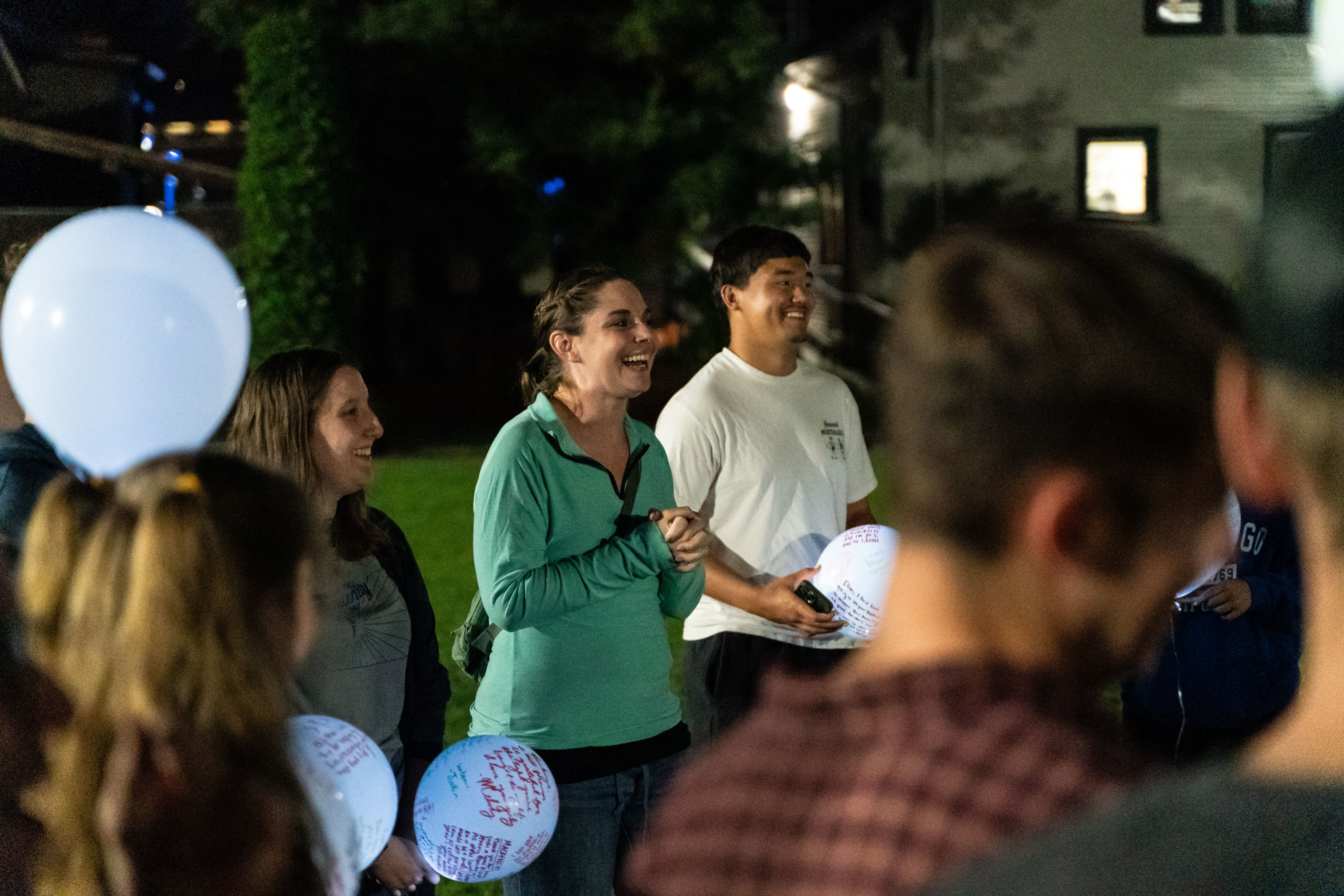 Bushnell staff member speaks to students during an evening campus event.
